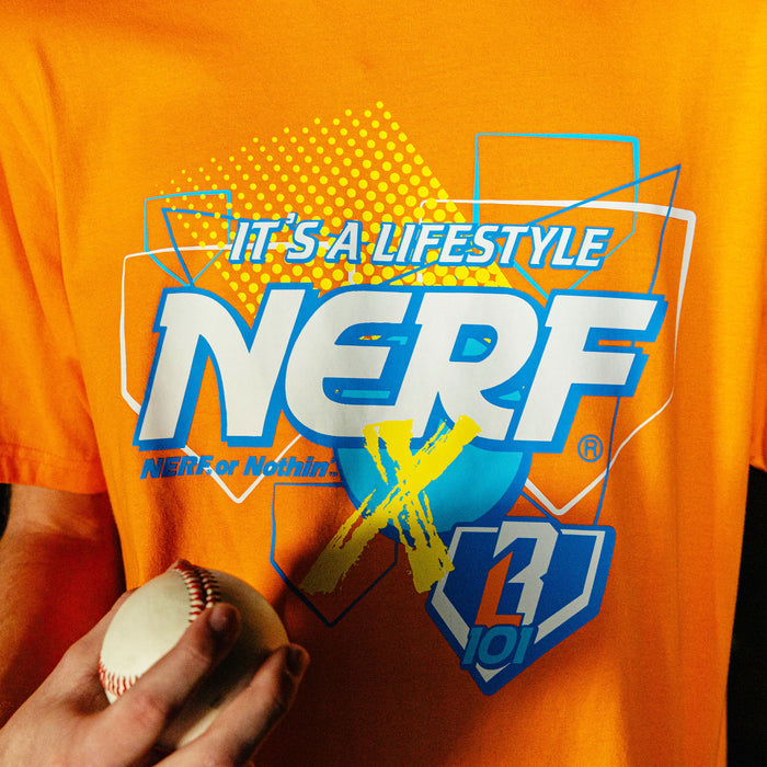 Orange t-shirt with 'NERF X BL101' t-shirt branding and a hand holding a baseball.