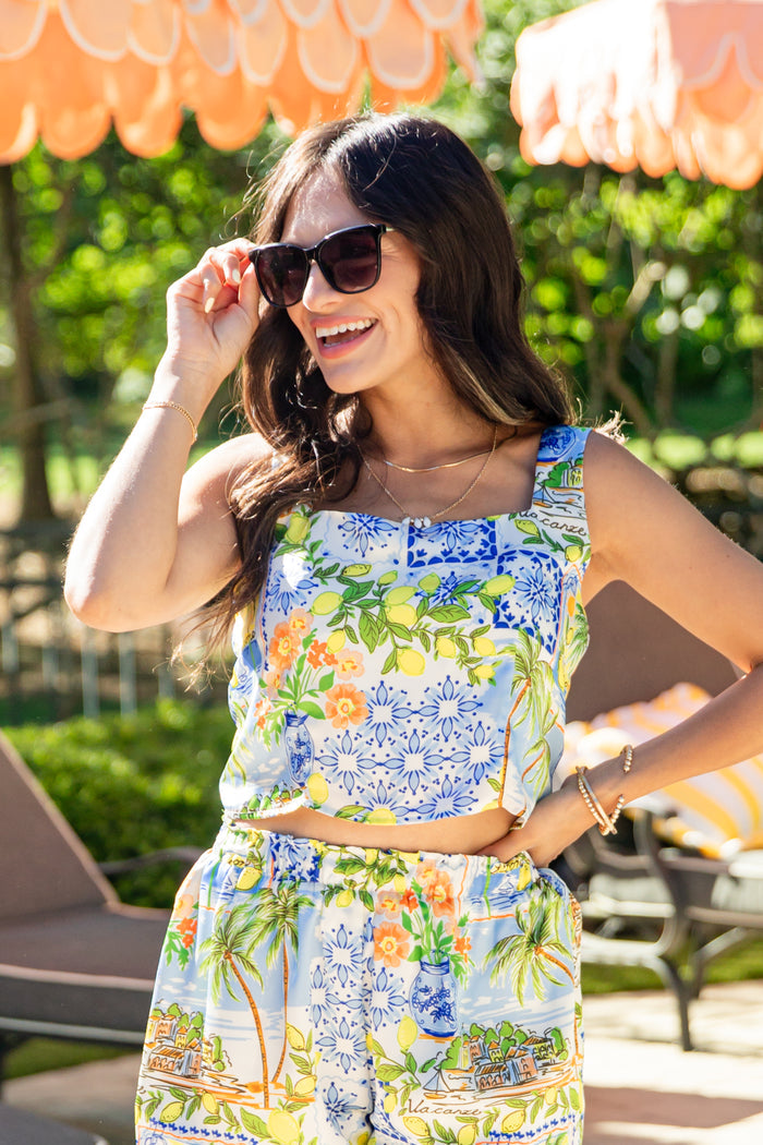 Woman wearing a colorful floral outfit in an outdoor setting
