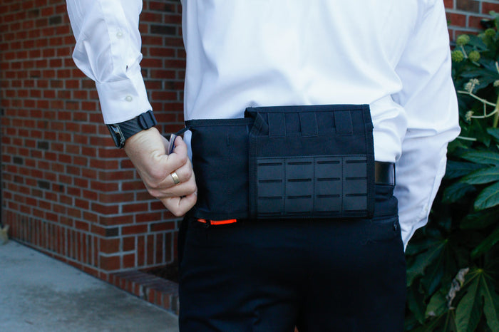 Rescue Essentials FLAT IFAK kit in concealed carry position attached to a belt.