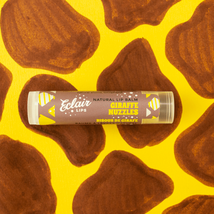 Eclair Lips Giraffe Nuzzles lip balm on giraffe print background