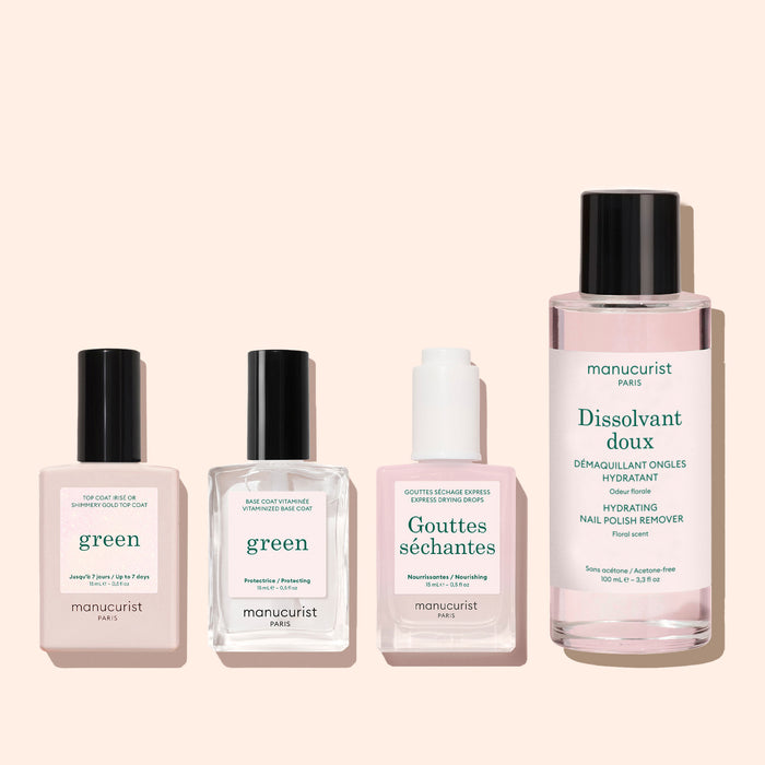 Four Manucurist bottles, including the Glitter Top Coat, are arranged in a row on a light pink background.