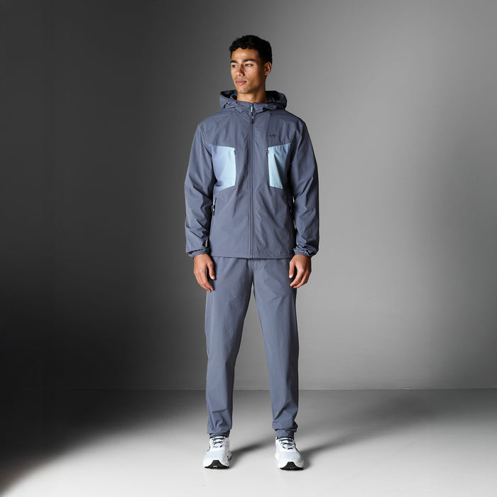 Gradient Motion Tracksuit in Charcoal/Mint, featuring a charcoal hooded jacket with contrasting mint chest panels, zip pockets and matching tapered pants.