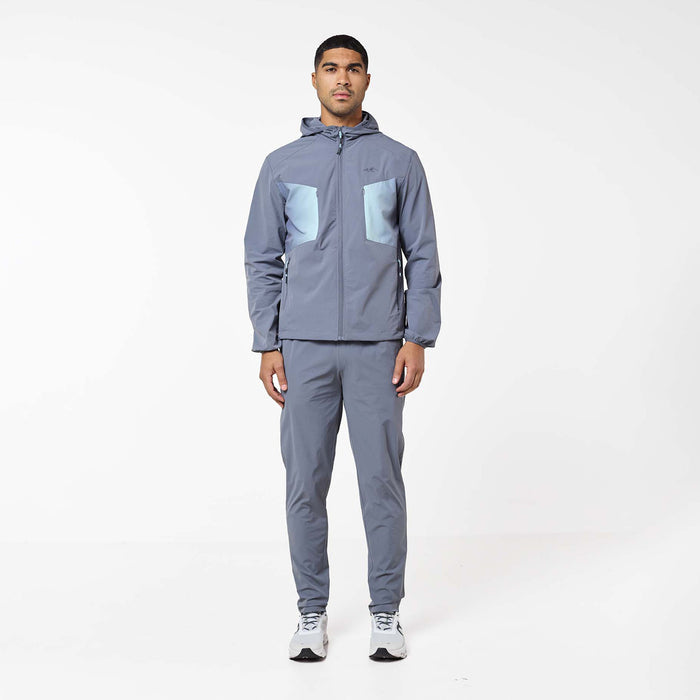 Front view of the Gradient Motion Tracksuit in Charcoal/Mint, featuring a hooded charcoal jacket with contrasting mint chest panels and matching tapered pants.