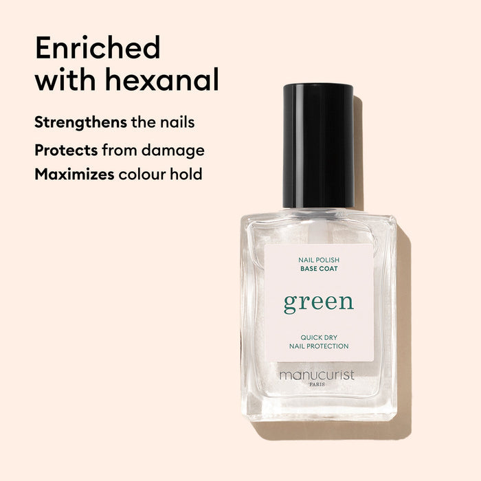 A clear bottle of Manucurist Green Base Coat with a black cap is shown on a beige background. The text notes this nail treatment is enriched with hexanal, strengthens nails, and helps your polish last longer.
