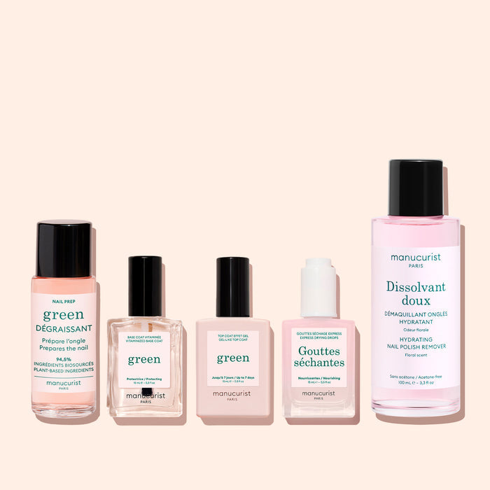 Five manicure products from Manucurist, including the Green™ Base, Top Coat  Nail Polish Remover Trio, are displayed in bottles and jars of varying sizes on a light background. The French and English labels showcase the brand and product names for nail and polish care with naturally derived formulas—perfect for achieving a flawless manicure.