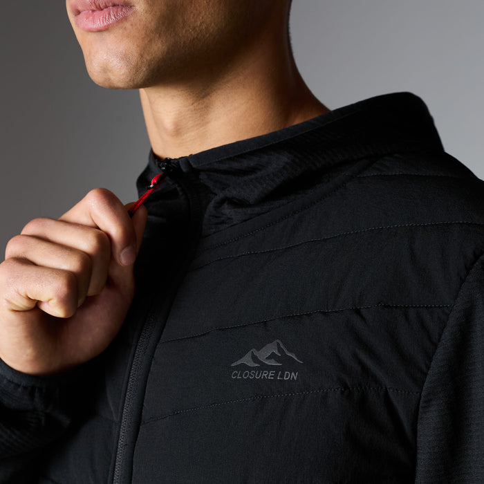 Close-up of black Grid Fleece Hybrid Tracksuit hoodie with quilted chest panel, Closure LDN logo and red zip puller