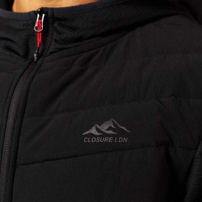 Close-up of black Grid Fleece Hybrid Tracksuit hoodie with quilted chest panelling, Closure LDN logo and red bungee zip puller