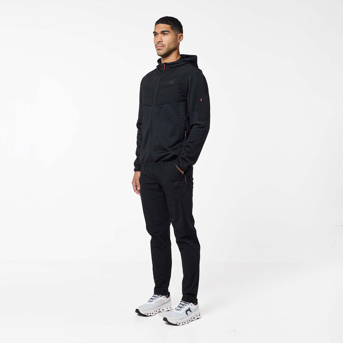 Model wearing black Grid Fleece Hybrid Tracksuit with quilted hooded jacket and tapered joggers