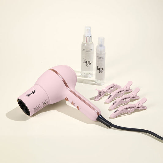Hot Stuff Blowout Set, featuring a Blush Hot Stuff dryer, Alligator Clips, Thermal Magique, and Satin Nectar, displayed on a beige background