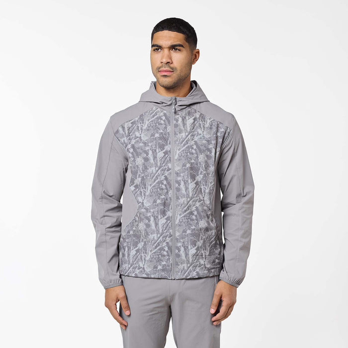 Front view of the Ignite Tracksuit jacket in Rock, highlighting the three-piece hood, full-zip fastening and contrasting printed front panels.