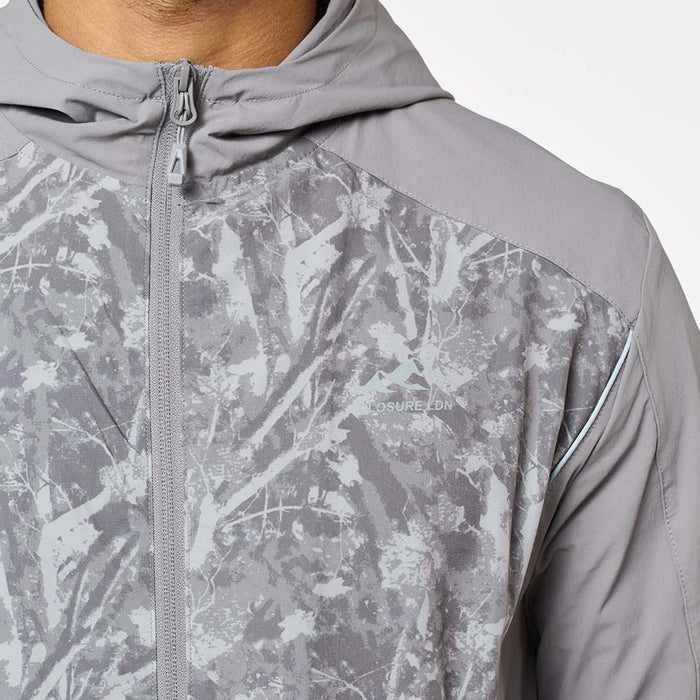 Close-up of the Ignite Tracksuit jacket in Rock, highlighting the printed chest panel, Closure London transfer logo, reverse zip and reflective piping detail.