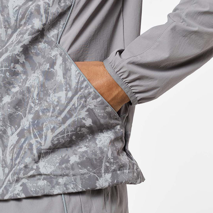 Close-up of the Ignite Tracksuit jacket in Rock, highlighting the printed panel, concealed in-seam pocket, reflective piping and elasticated cuff.