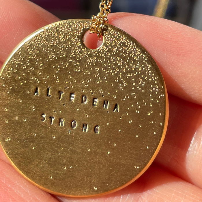Gold round pendant with diamond-dusted finish and engraved 'ALTEDENA STRONG' text