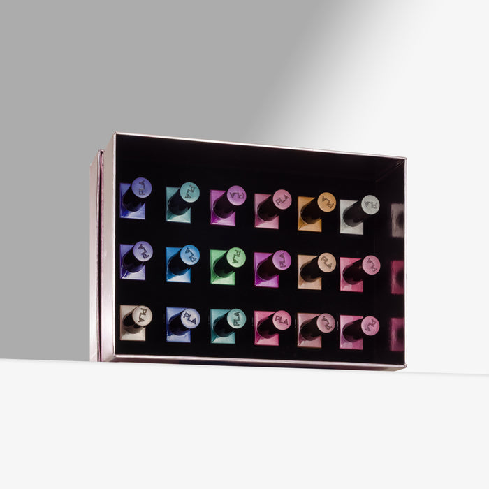 A rectangular black display box containing 18 nail polish bottles in assorted colors, photographed on a clean white surface against a light gray background.