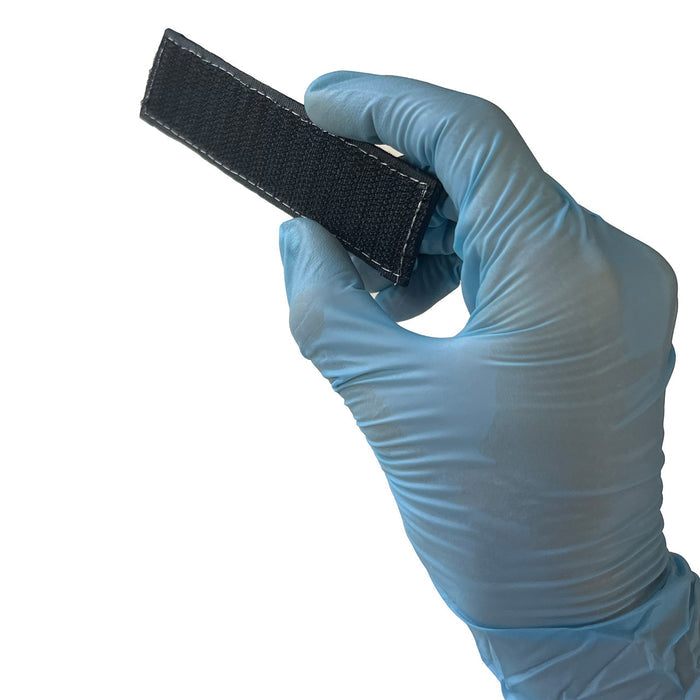 TRAINER Name tape, Back angled in hand