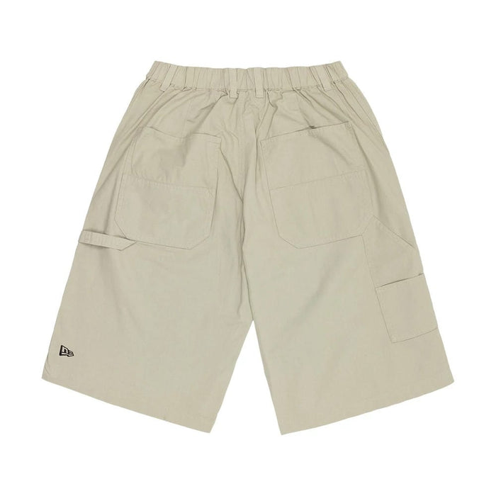 The model is wearing this New Era Canvas Bermuda Shorts in beige. 6