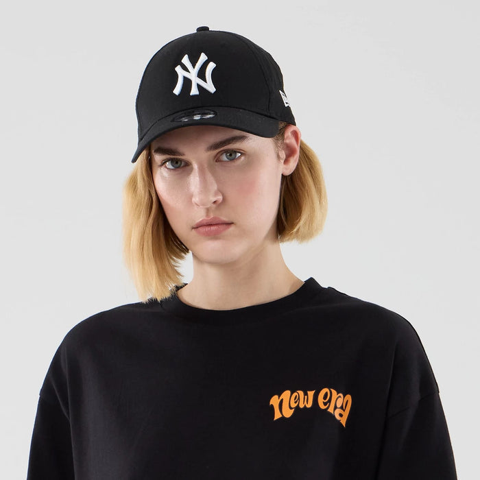 The model is wearing this New Era Hot Dog Graphic Oversized T-Shirt in black. 6