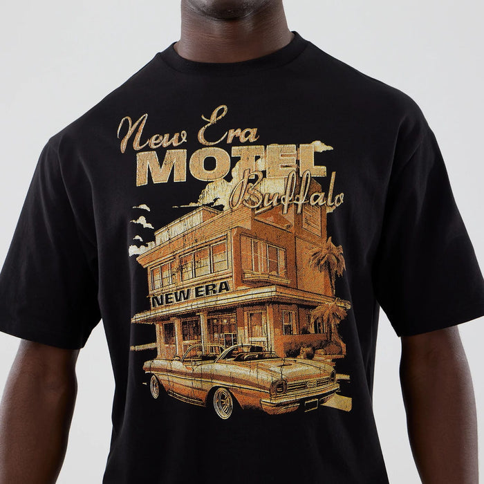 The model is wearing this New Era Motor Graphic Oversized T-Shirt in black. 4