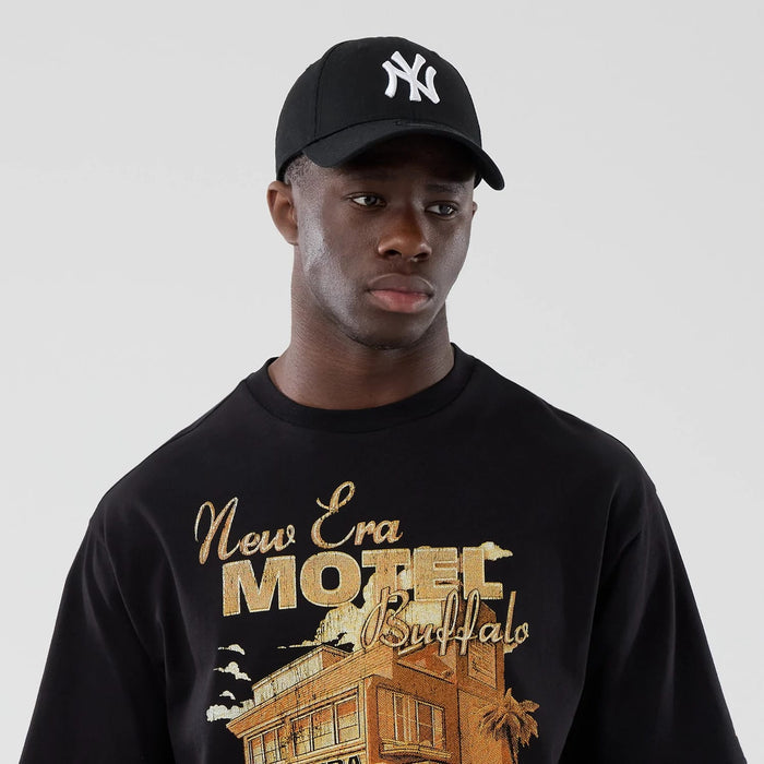 The model is wearing this New Era Motor Graphic Oversized T-Shirt in black. 6