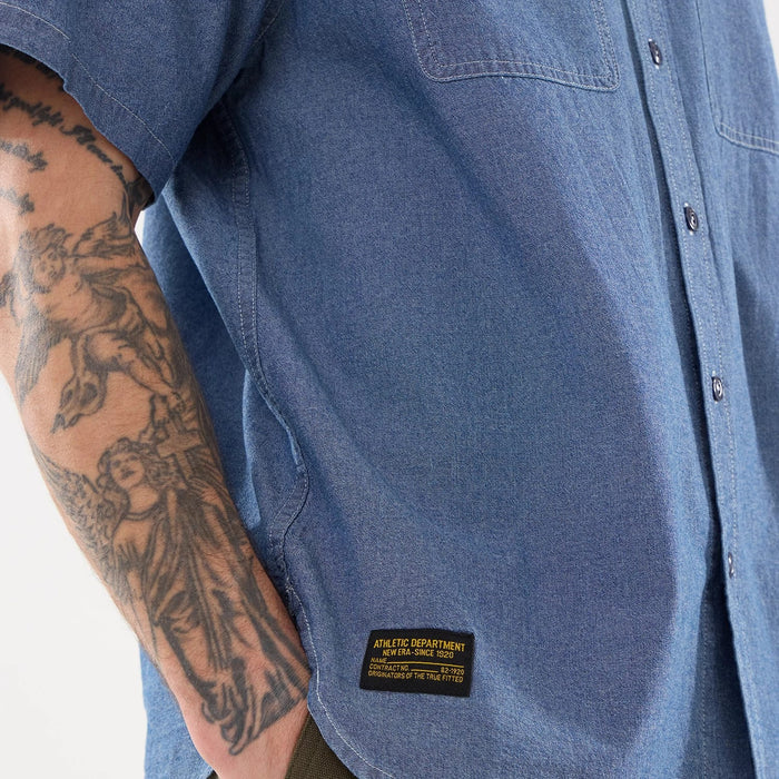 The model is wearing this New Era Originators Chambray Short Sleeve Shirt in dark blue. 6