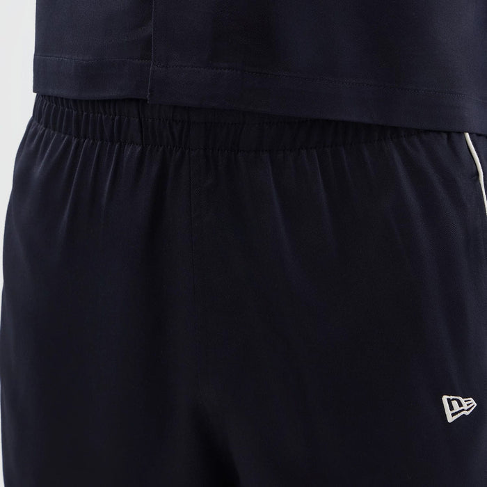 The model is wearing this New Era Piping Shorts in navy. 5