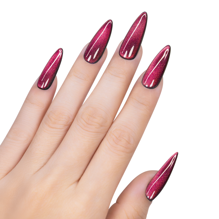 Hand with long, pointed nails painted in a glossy pink color on a white background