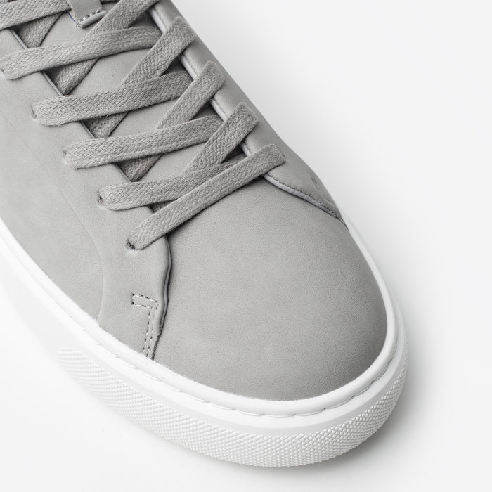 Close-up of the Premium Classic Trainer in Grey, highlighting the smooth grey PU toe box, tonal lace-up fastening, stitching and textured cup sole.