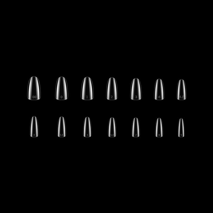 Set of clear nail tips on a black background
