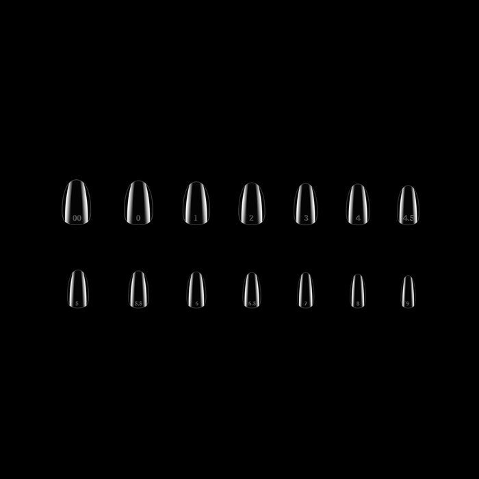 Set of clear nail tips on a black background