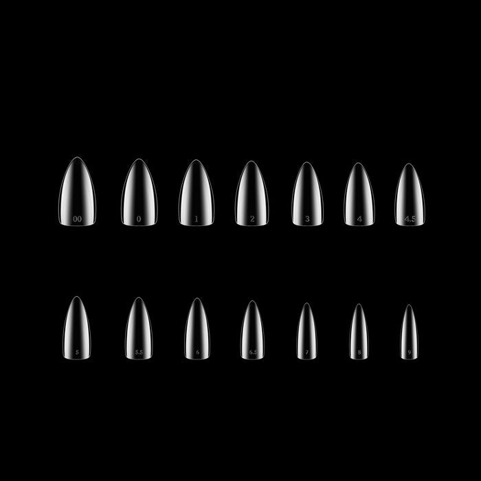 Set of clear stiletto-shaped nail tips on a black background