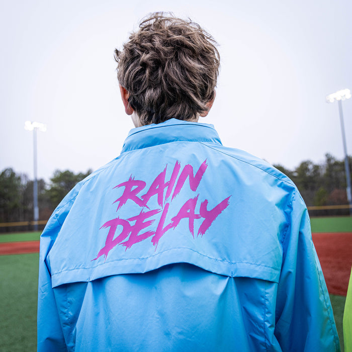 Youth model wearing blue Rain Delay Jacket Cotton Candy Blue youth jacket