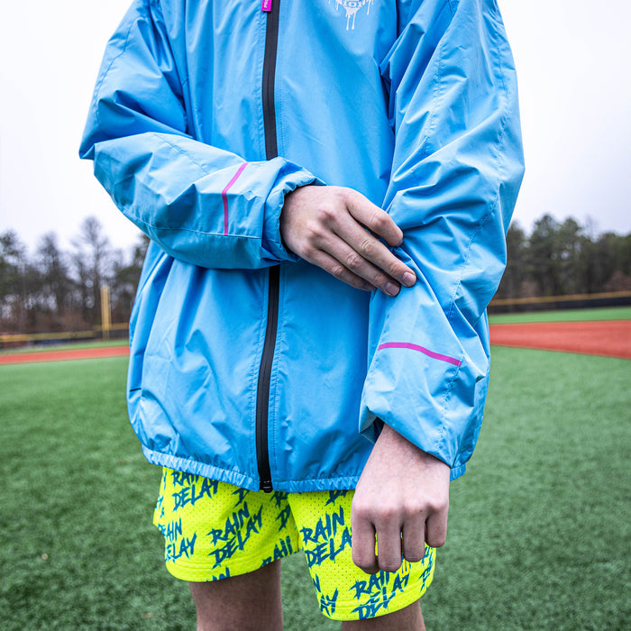 Youth model wearing blue Rain Delay Jacket Cotton Candy Blue youth jacket