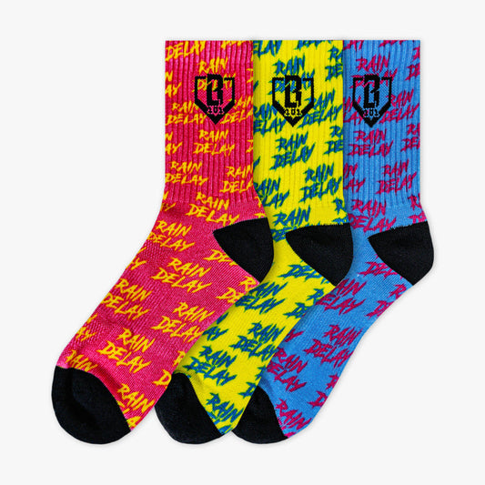 Adult model wearing multi-color socks with "Rain Delay Performance  3-Pack" design