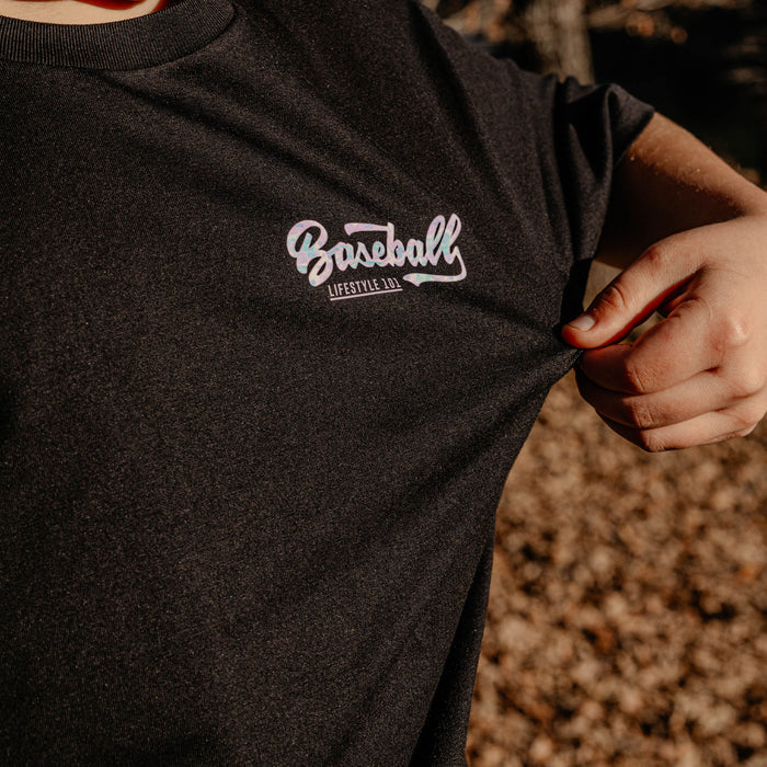 Black t-shirt with 'Baseball Lifestyle' logo held by a person outdoors.