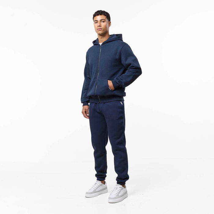 Full front view of model wearing navy tracksuit