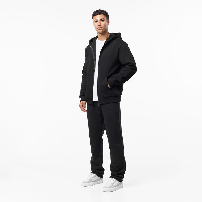 Men's black zip up hoodie open with white t-shirt paired with black straight leg