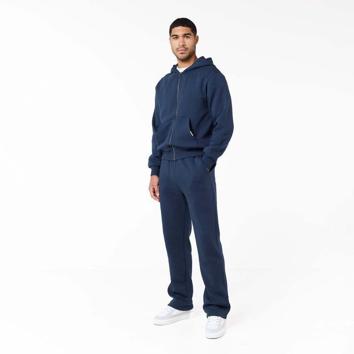 Model wearing full zip tracksuit set in navy