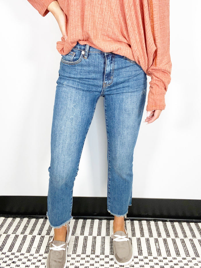 Risen Mid Rise Medium Wash Raw Hem Straight Jeans