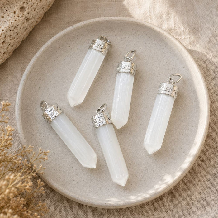 Three Selenite point pendants with silver-plated bails.