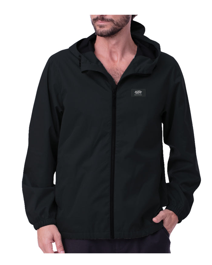 Man wearing a black Selkirk Spring Owen Men's Bunker Lightweight Hooded Windbreaker with a hood and front zipper, shown from mid-thigh up.