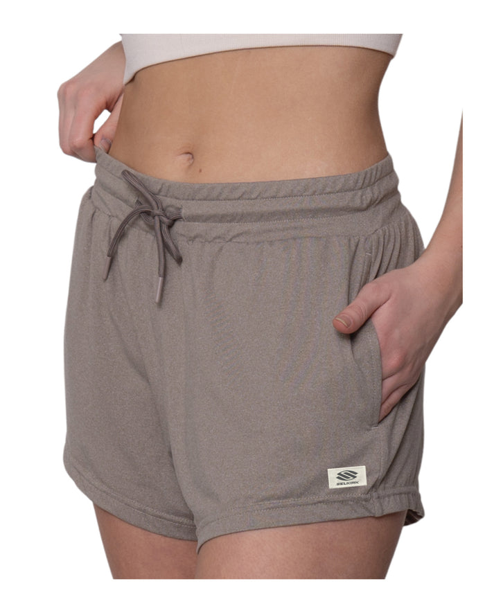 Taupe drawstring lounge shorts with side pockets, worn by model cropped at the midriff