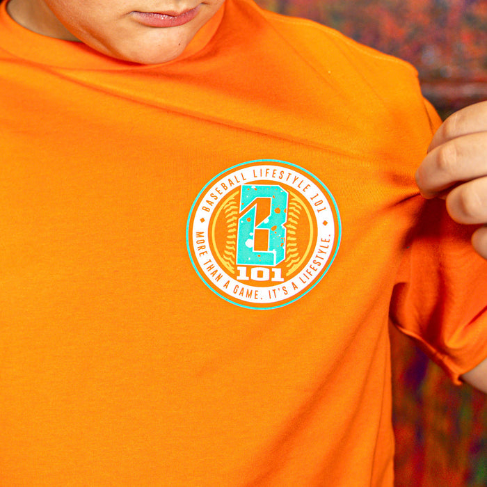 Person wearing an orange t-shirt with a BL101 logo on the chest