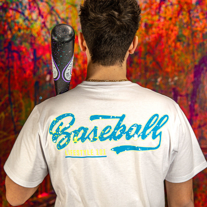 Person wearing a white t-shirt with 'Baseball Lifestyle' text, holding a bat against a colorful abstract background.