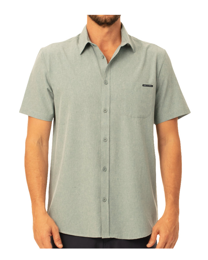Front view of Spring Owen Men’s Horizon Tech Short Sleeve Button Down showcasing pale green fabric and chest pocket