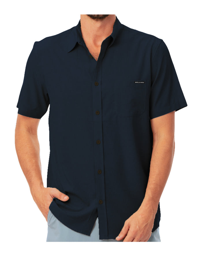 Men's navy short-sleeve button-up shirt with chest pocket, model's hands in pockets, untucked hem.