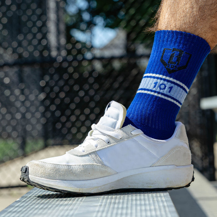 Adult model wearing red, white & blue socks with "Stadium Performance  3-Pack" design