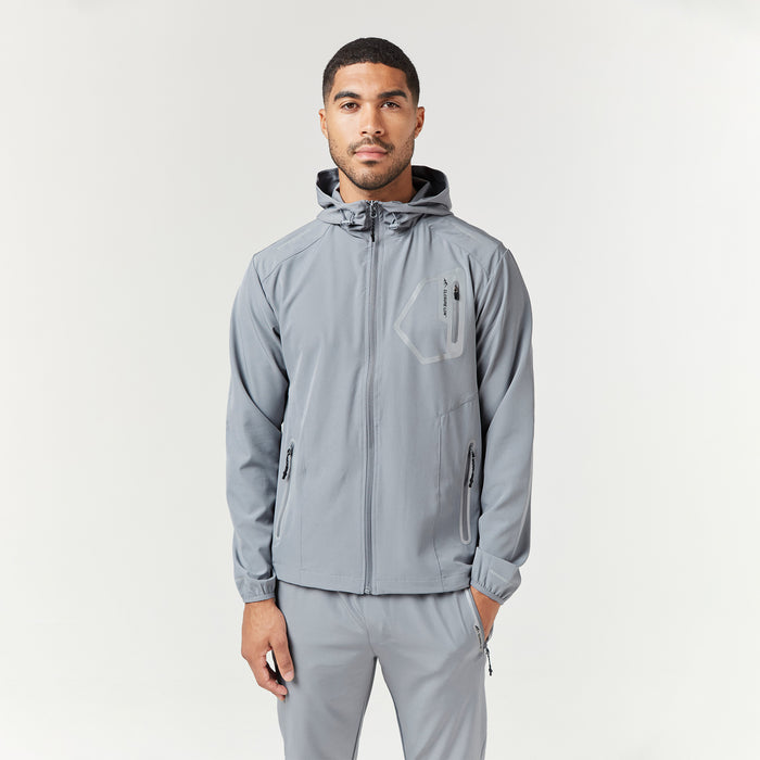 Male model looking into camera wearing tech tracksuit jacket