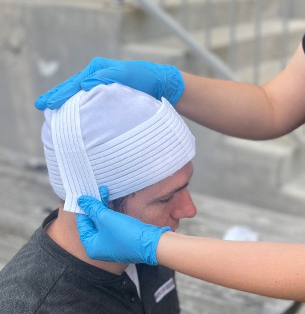Rescue Essentials Trauma Cap, being put on
