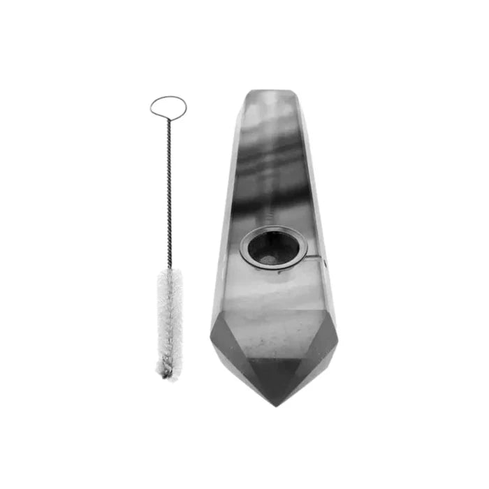 Front view of the Valiant Crystal Pipe-Obsidian, a dark, sleek glass pipe with a cleaning brush beside it.
