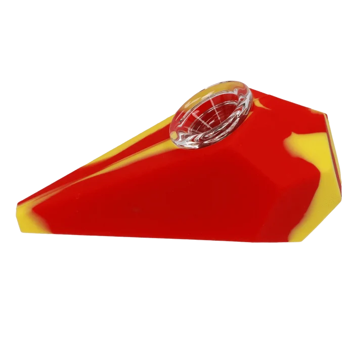 Angled close-up of the red-and-yellow Valiant Silicone Diamond Pipe - Assorted showing its clear glass bowl recessed into a faceted silicone body.